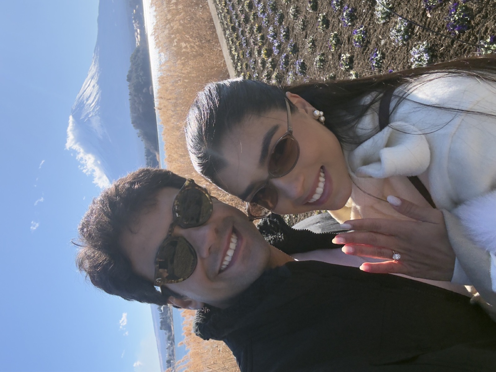 Gabriela mostrando a aliança, com José e o Monte Fuji ao fundo